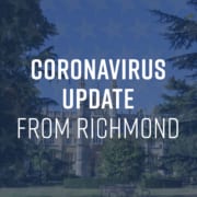 A tree stands in an outdoor setting with a text banner reading "CORONAVIRUS UPDATE FROM RICHMOND" draped across its branches.