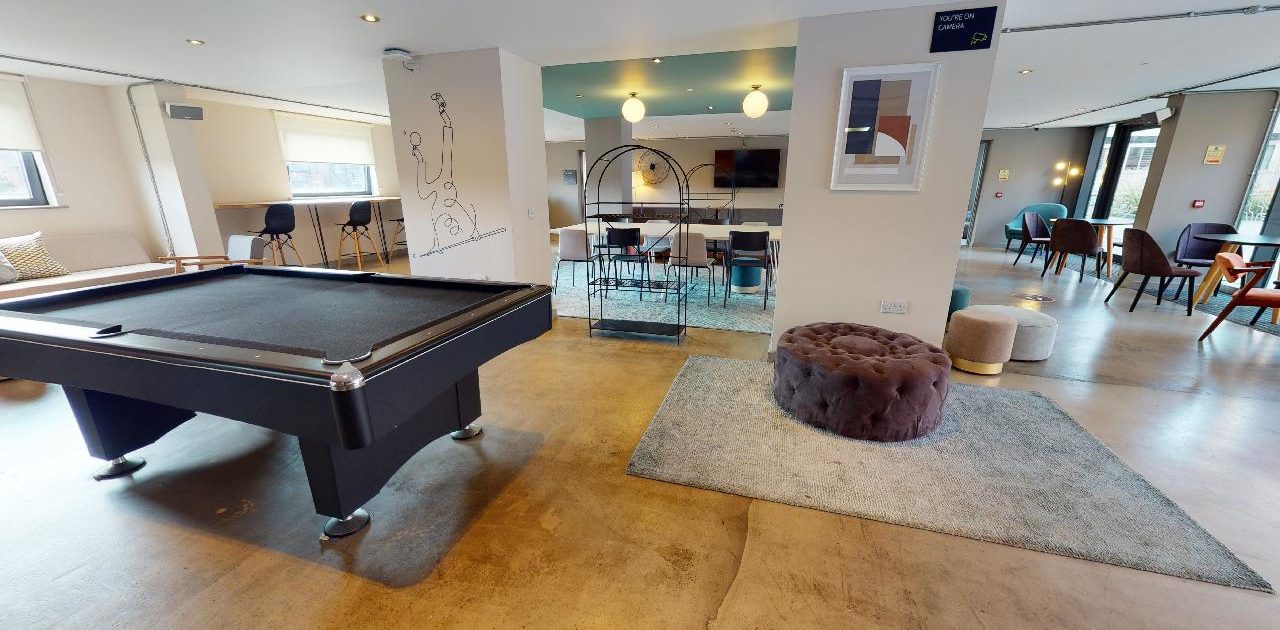 The pool table and chairs occupy the room.