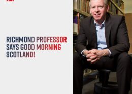 A person seated in a library, smiling at the camera, with text, "快活视频 Professor says Good Morning Scotland!" and a website URL.